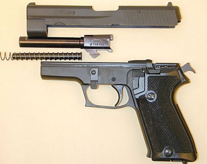 Early 9mm SIG-Sauer P220 pistol partially disassembled.