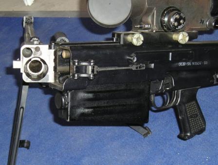 12.7mm OSV-96 rifle with barrel foldedhalf-way to the right, exposing barrel breech area and gas tube exit.Note the barel clamp / lock on the receiver above the magazine.
