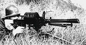 Chinese soldier fires an early version of the 35mm W87 automatic grenade launcher, fitted with drum magazine.