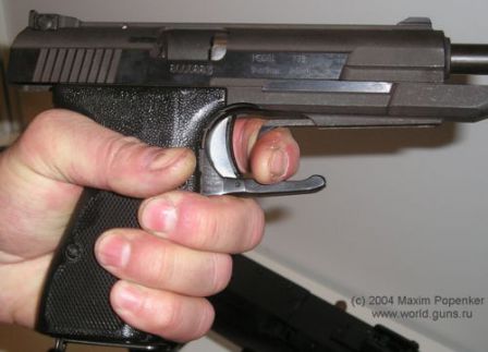 NORINCO Model 77B pistol, showing its single hand slide cycling capability (using front of the trigger guard).