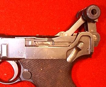 A view to proprietary Lugers' locking mechanism - the breechblock is at the rearmost position.