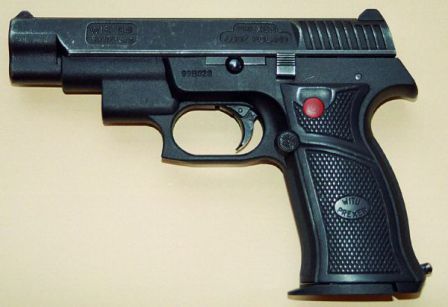 WIST-94L pistol with integral laser aiming module, built into the hump in front of the trigger guard. Red button on the left grip panel turns the laser on when pressed.