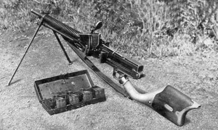 Type 11 light machine gun, loaded and ready to fire. Note that the hopper is filled with clips, and additional clips are held in special carrying case next to the gun.