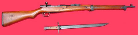 7.7mm Arisaka Type 99 rifle and bayonet in scabbard; bolt cover removed.