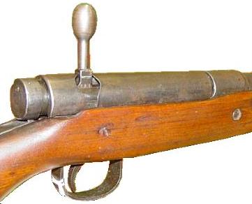  7.7mm Arisaka Type 99 rifle, close-up view on the receiver, bolt cover installed, bolt handle is turned up and ready to be pulled back.