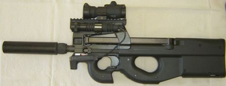 FN P90 TR (triple rail version) personal defense weapon / submachine gun, with installed accessories including optical sight on top rail, flashlight on left rail, and silencer on the barrel.