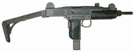  Uzi submachine gun with metallic buttstock in opened position.