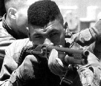 US marine aiming with the Remington 870 pump-action shotgun