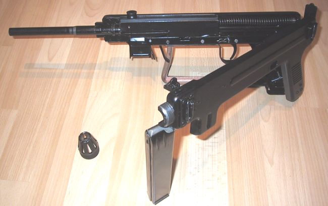 Madsen model 1950 submachine gun; receiver is partially opened for disassembly.